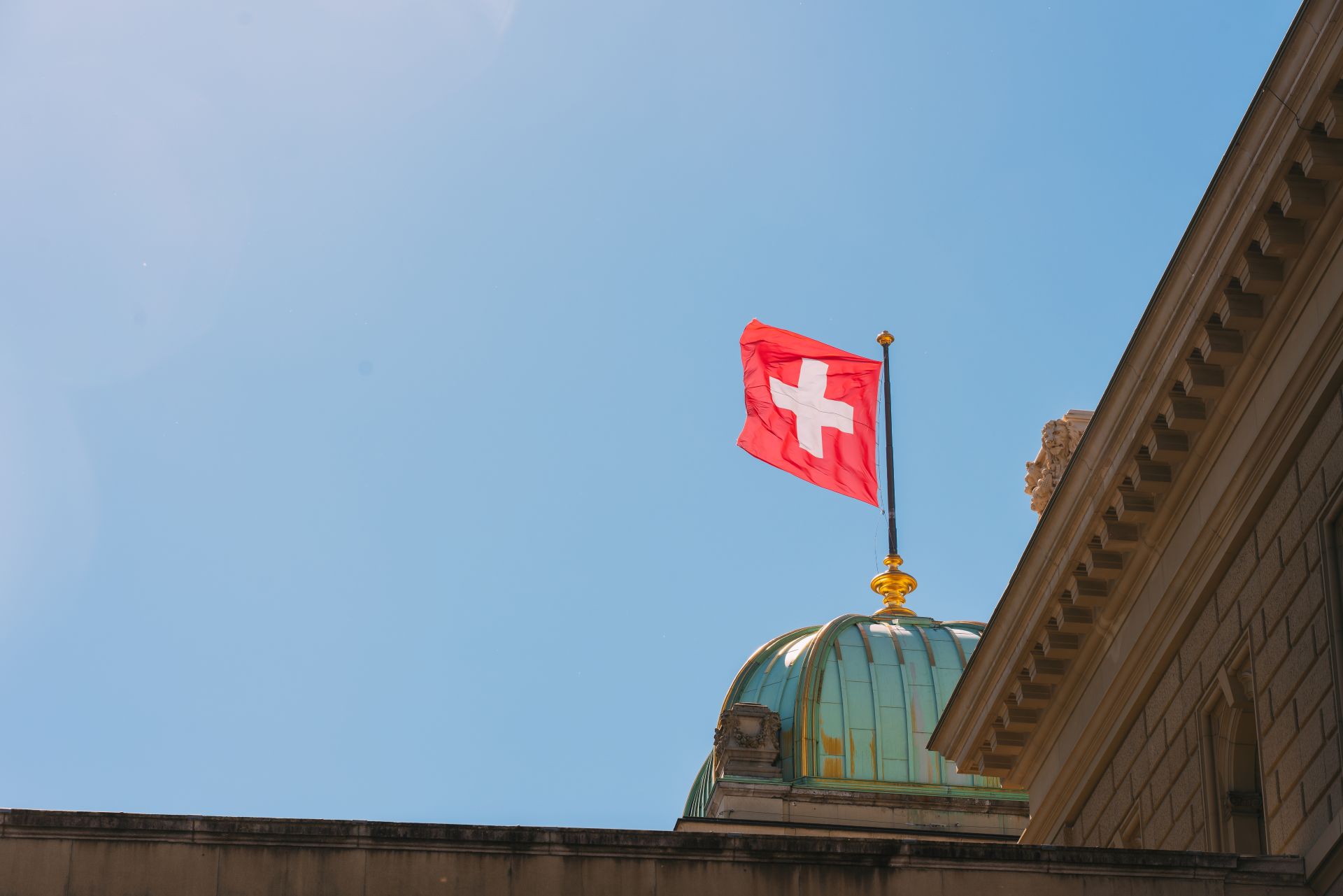 swiss-national-flag-above-federal-palace-bern